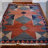 DR06. Geometric pattern wool rug. Measures approx. 5'4” x 7'10” 